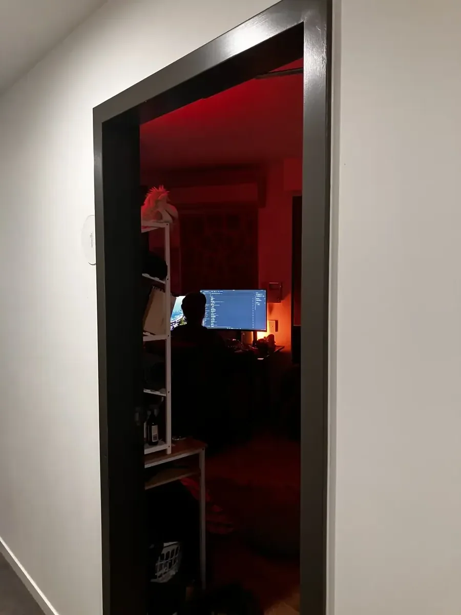 Ezra's desk in red light, seen through a doorway